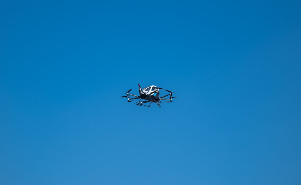 A small propeller plane flying through a blue sky