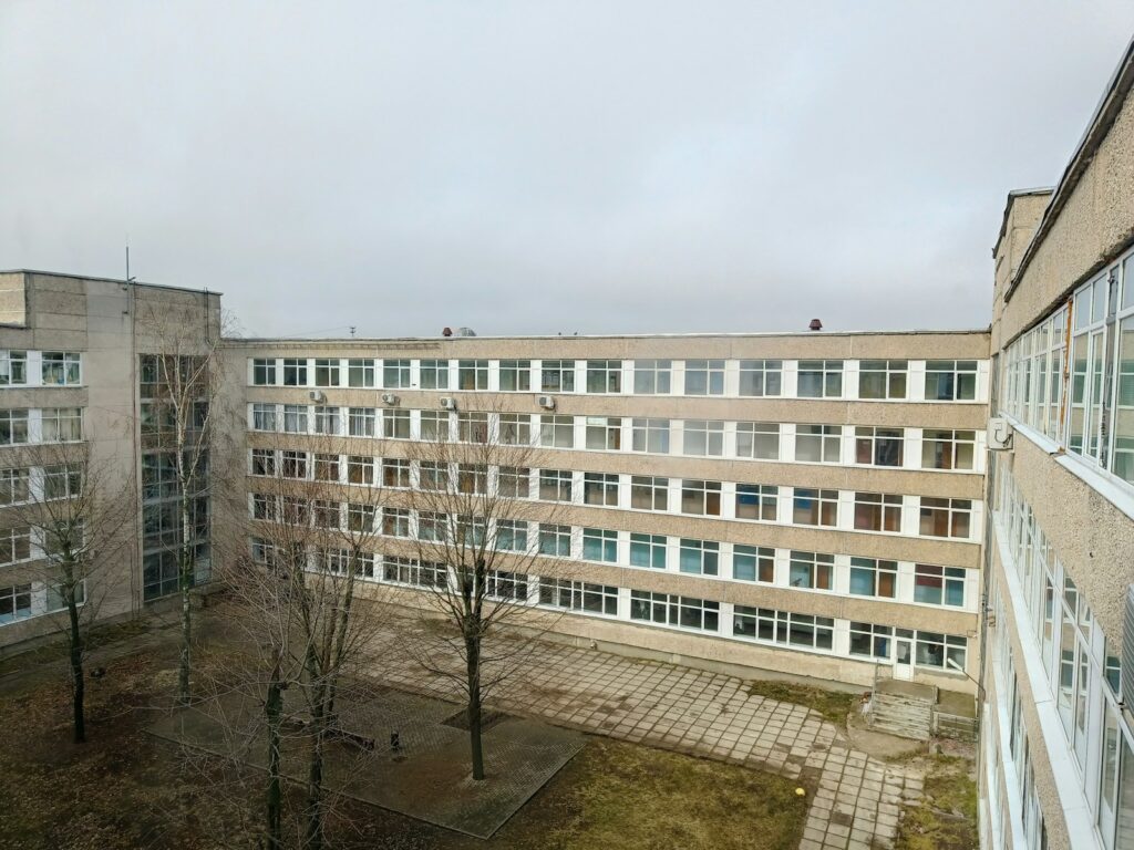 A large, grey building on a cloudy day.