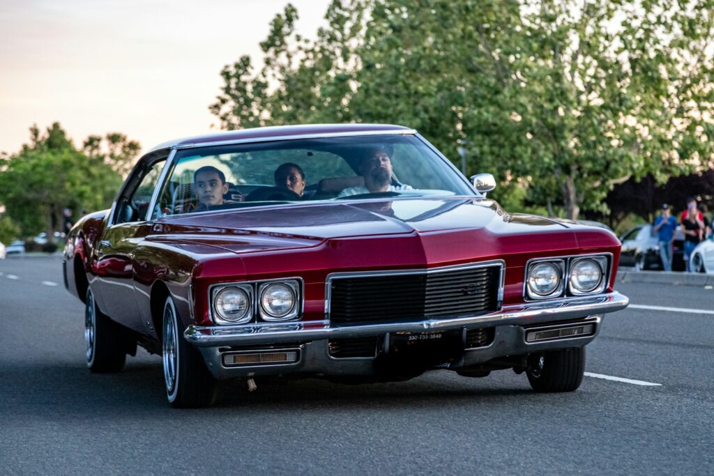 red chevrolet camaro on road during daytime
