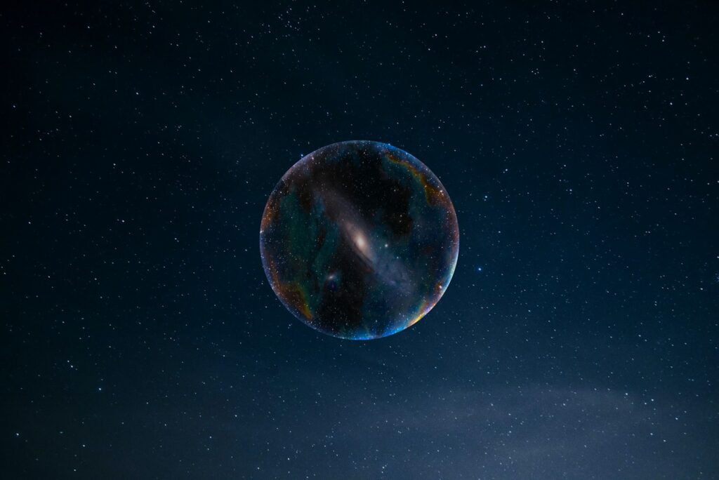 a large bubble floating in the air with stars in the background