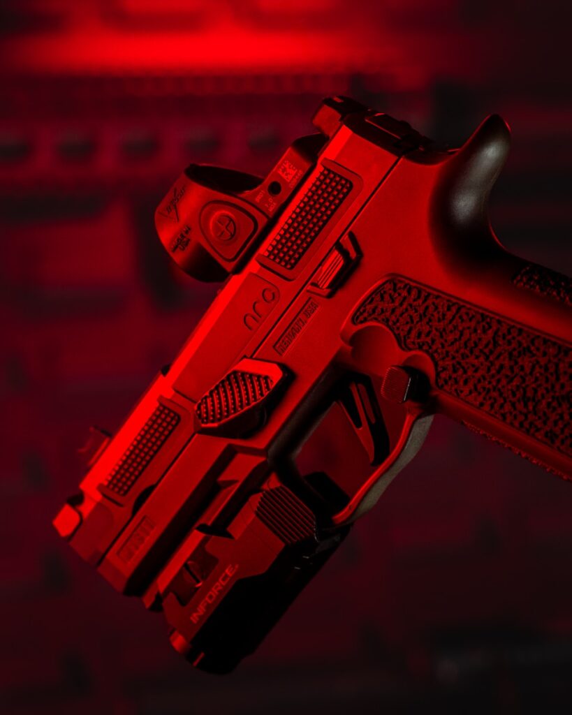 a close up of a red gun on a black background