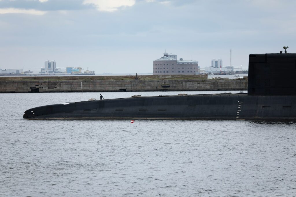 A large submarine docked in the water.