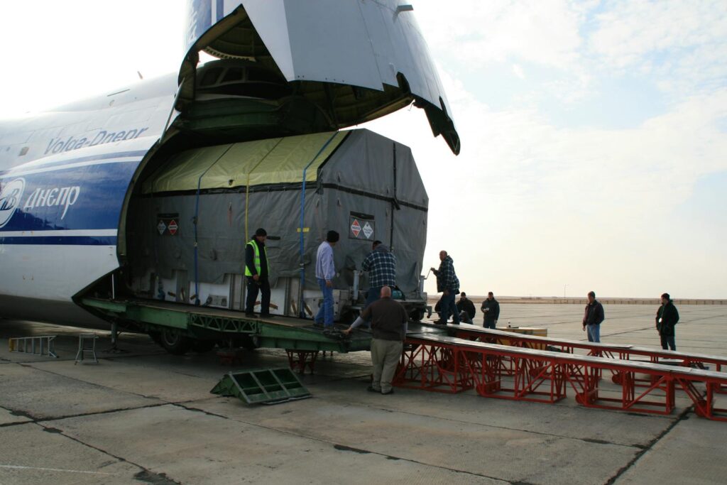 Team unloading cargo from aircraft at Baikonur spaceport.