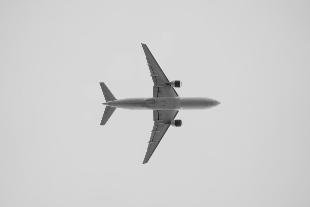 a large jetliner flying through a cloudy sky