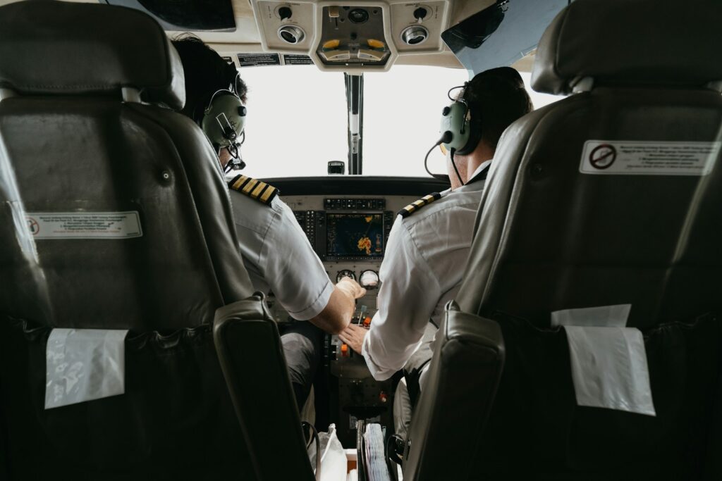 two pilots sitting in the cockpit of a plane