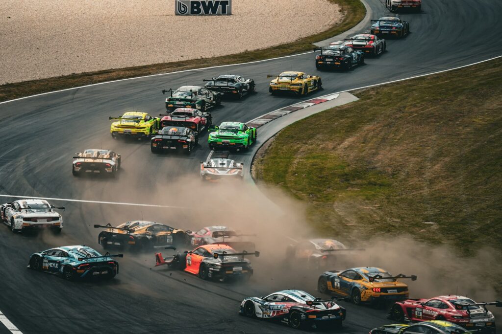 Race cars speed around a track.