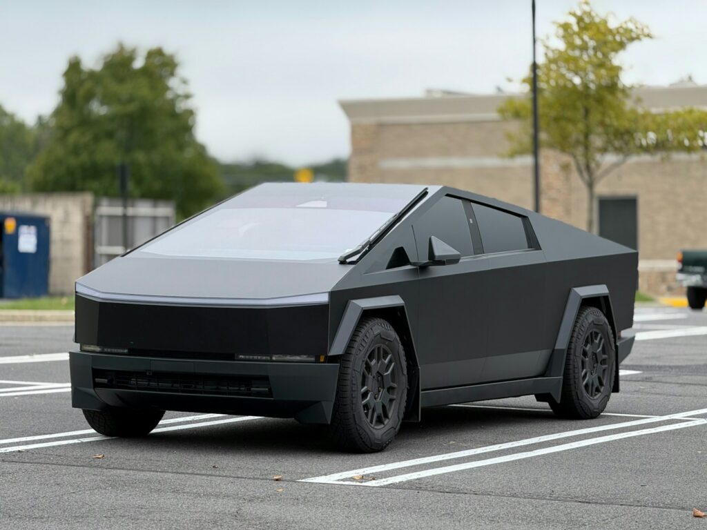 A futuristic car is parked in a parking lot