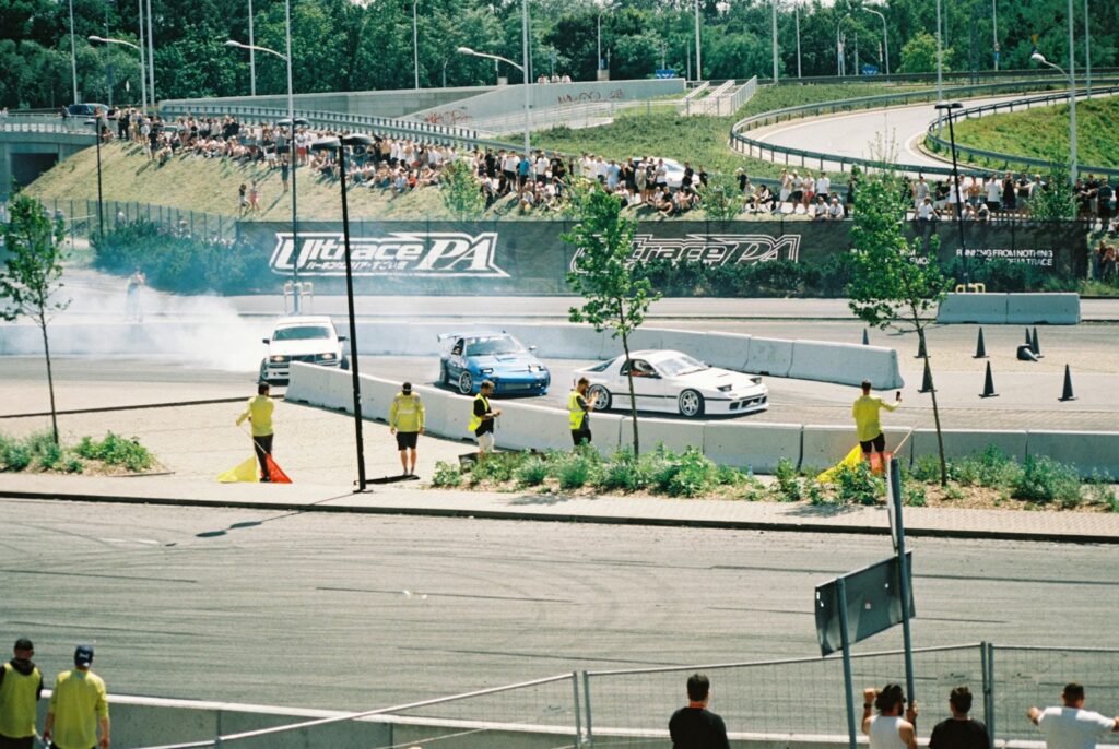 Cars are drifting in a professional race track.