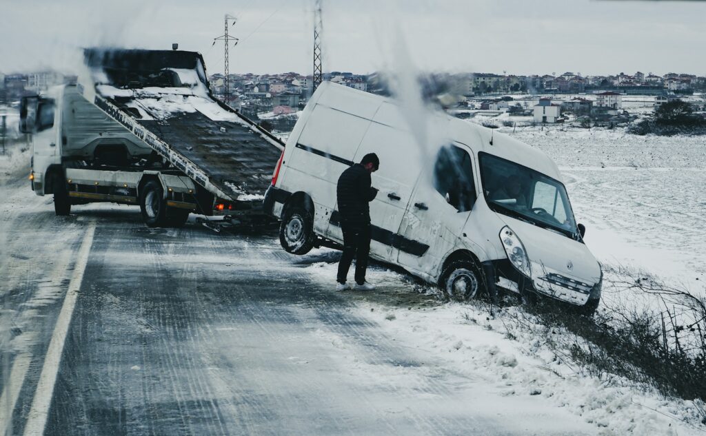 a man standing next to a white van on the side of a road