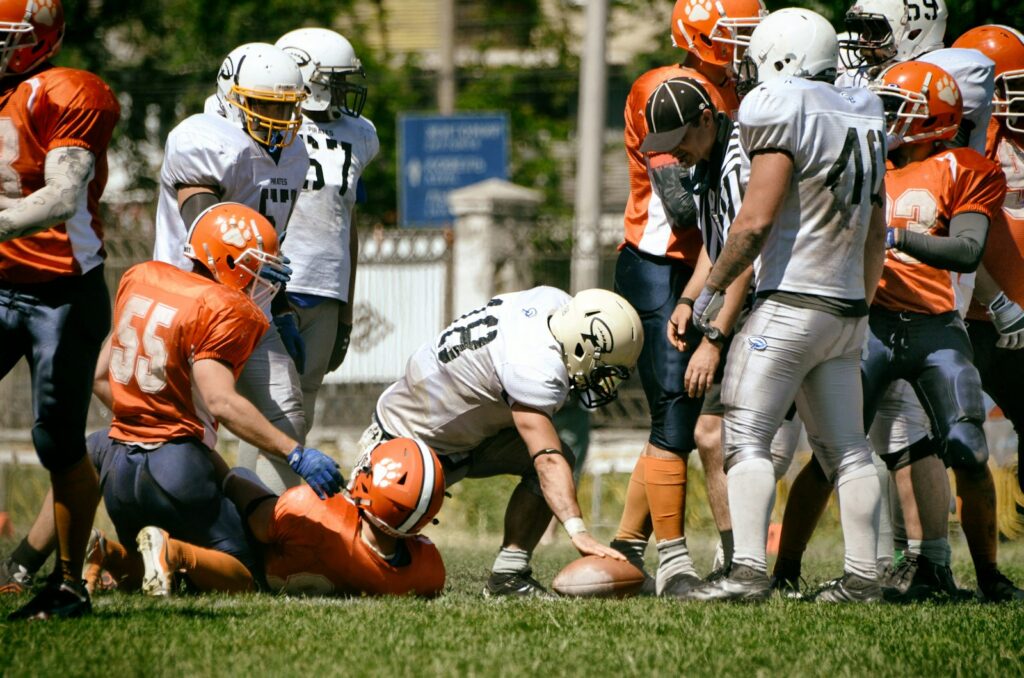 a group of football players standing on top of a field