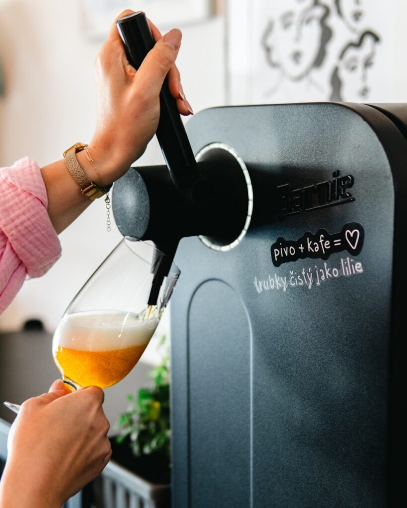 A woman is pouring a glass of beer