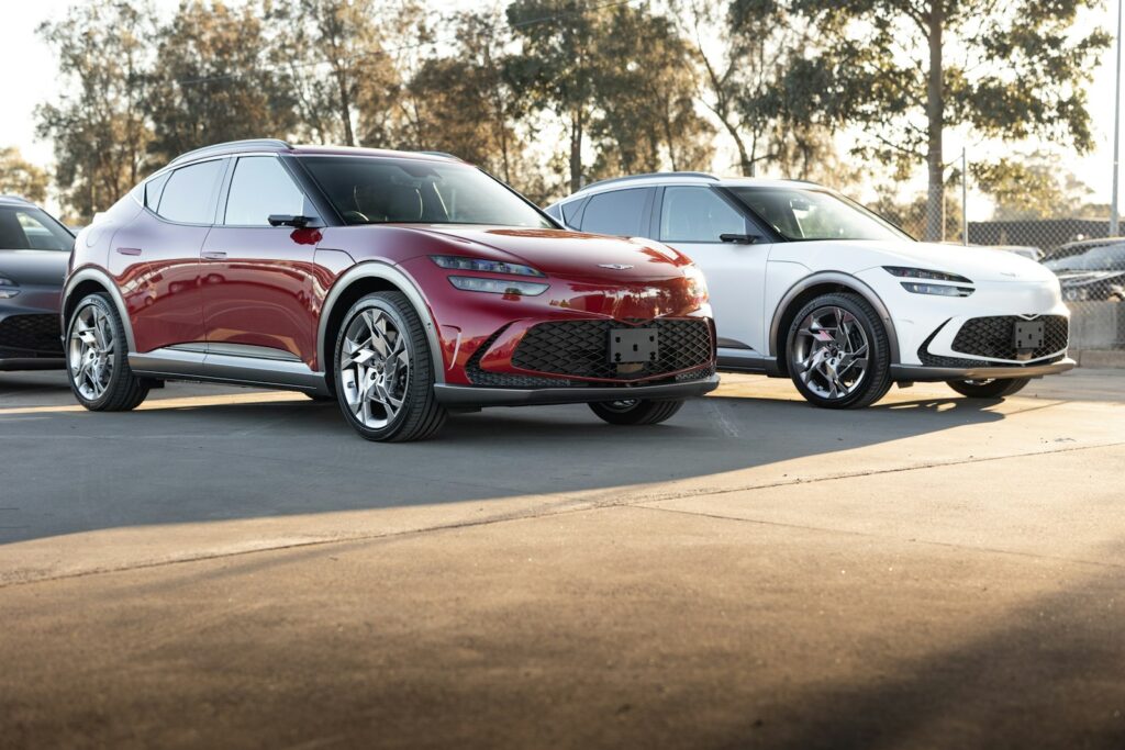 Two red and white cars are parked.