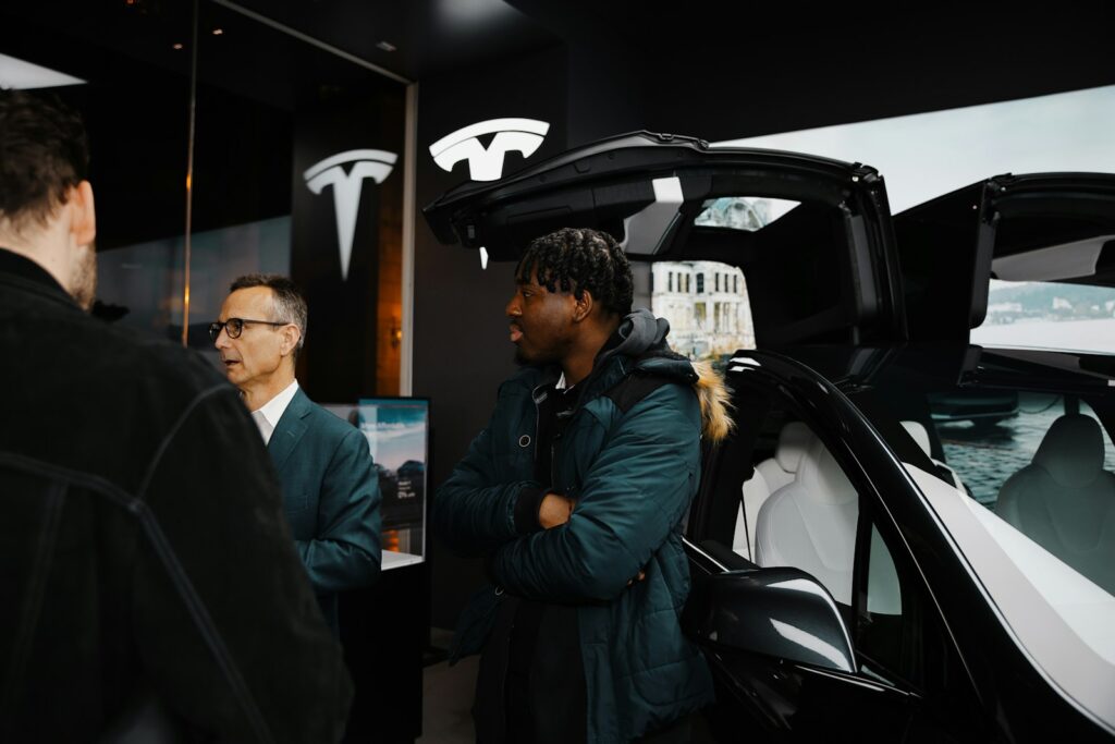 A group of people standing around a car