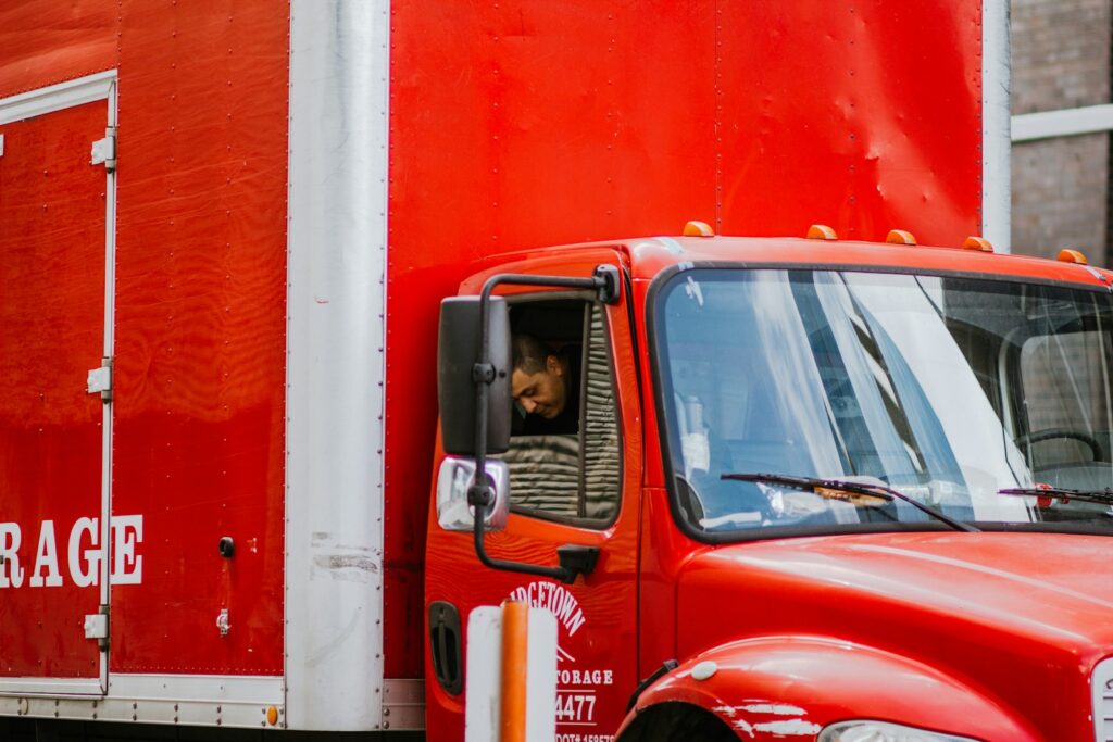 red and white truck in front of orange wall