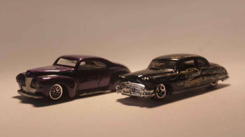 a couple of toy cars sitting on top of a table