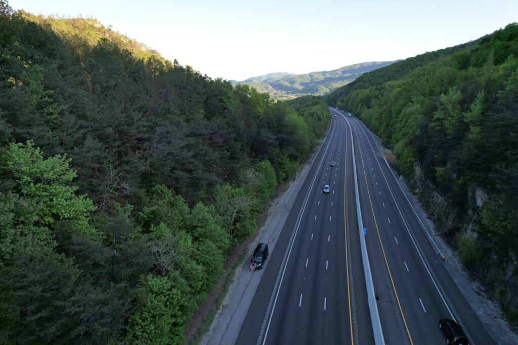 an aerial view of a highway in the mountains