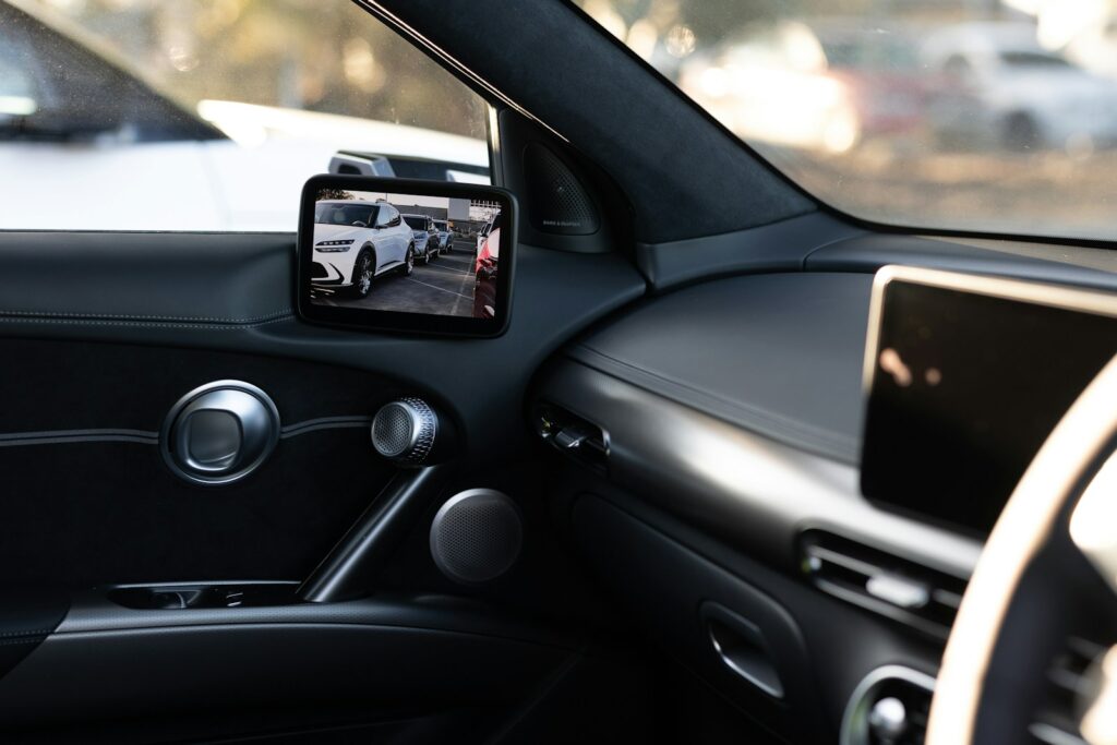 Car's interior, rearview mirror shows exterior view.