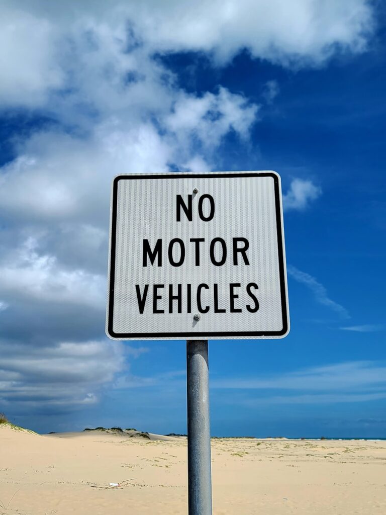 a no motor vehicles sign on a beach