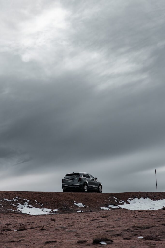 a car parked on top of a snow covered hill