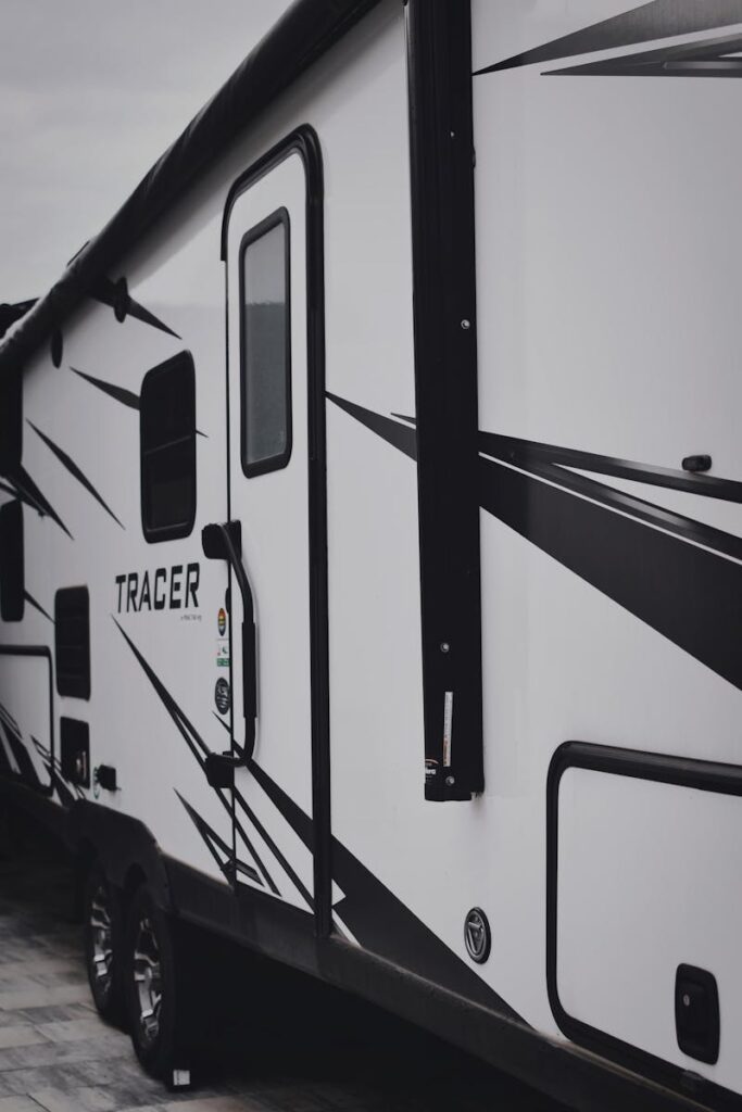 Stylish black and white camper van for travel and vacation exploration.