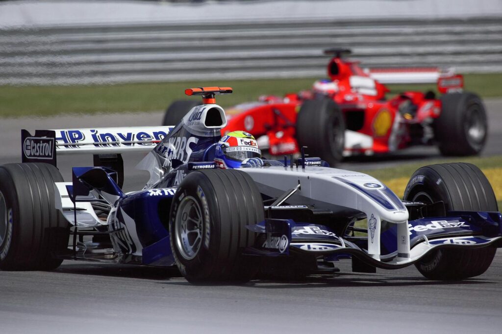 Close-up of two Formula 1 cars racing at high speed during a championship event.
