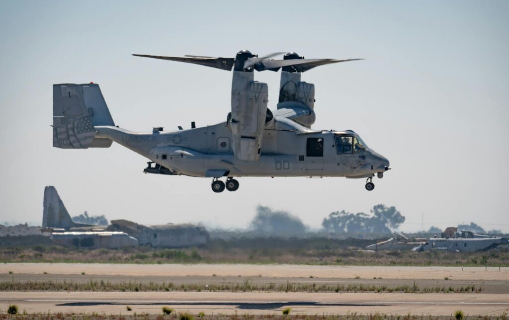 Military Bell Boeing V-22 Osprey aircraft flying over Miramar, CA runway.