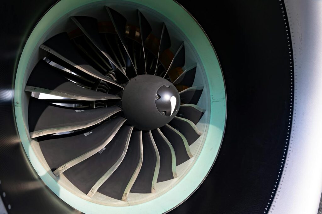 Detailed close-up of jet engine turbine blades showcasing engineering precision on an aircraft.