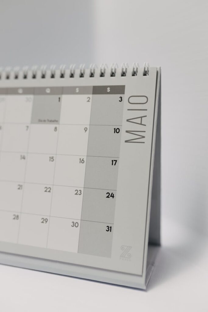 Close-up of a minimalist desk calendar displaying the month of May.