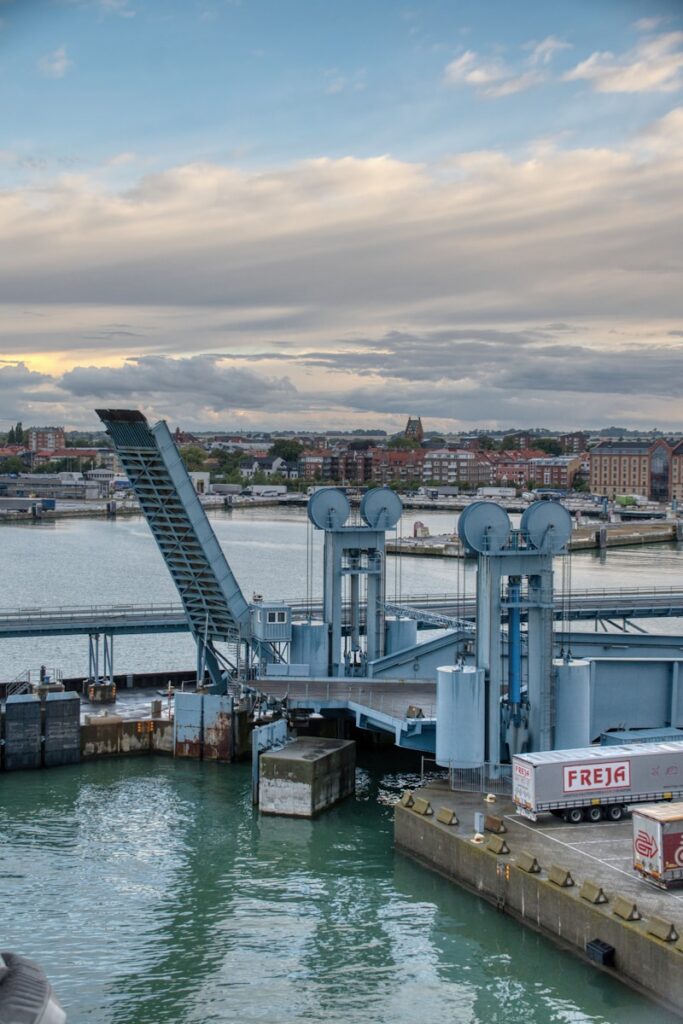 Ferry terminal with trucks and city skyline