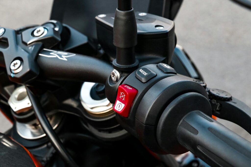 Detailed close-up of motorcycle handlebar controls and throttle grip.