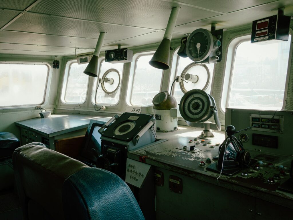 Inside the ship's bridge, navigation instruments visible.