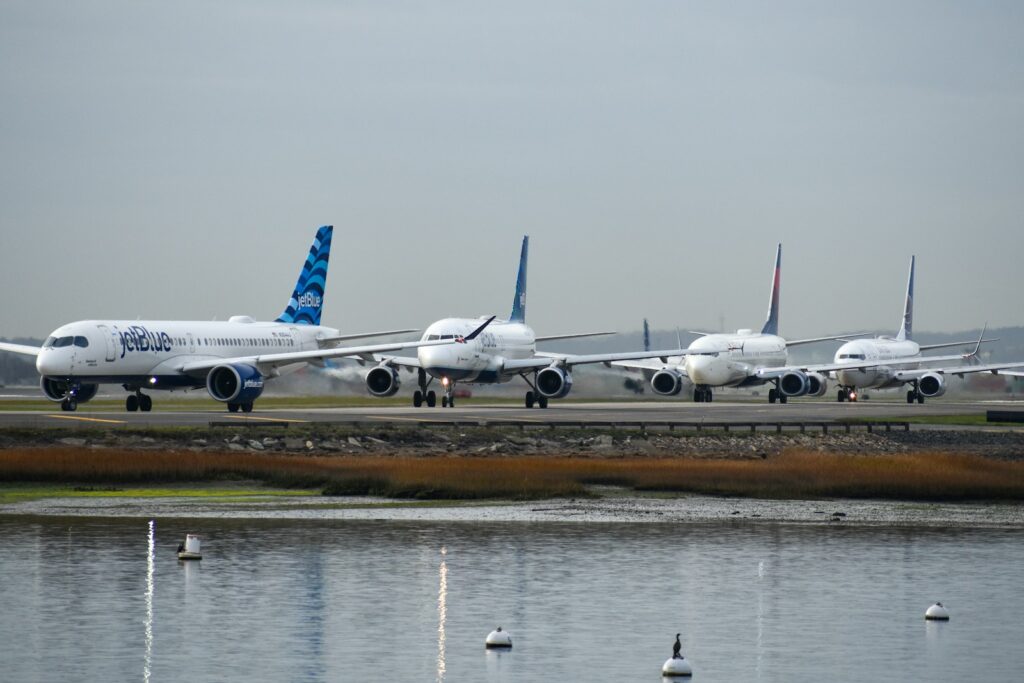 A row of airplanes sitting on top of an airport runway