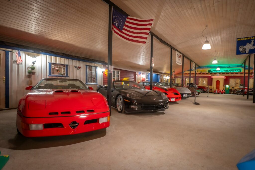 Classic cars are displayed in an enclosed showroom.