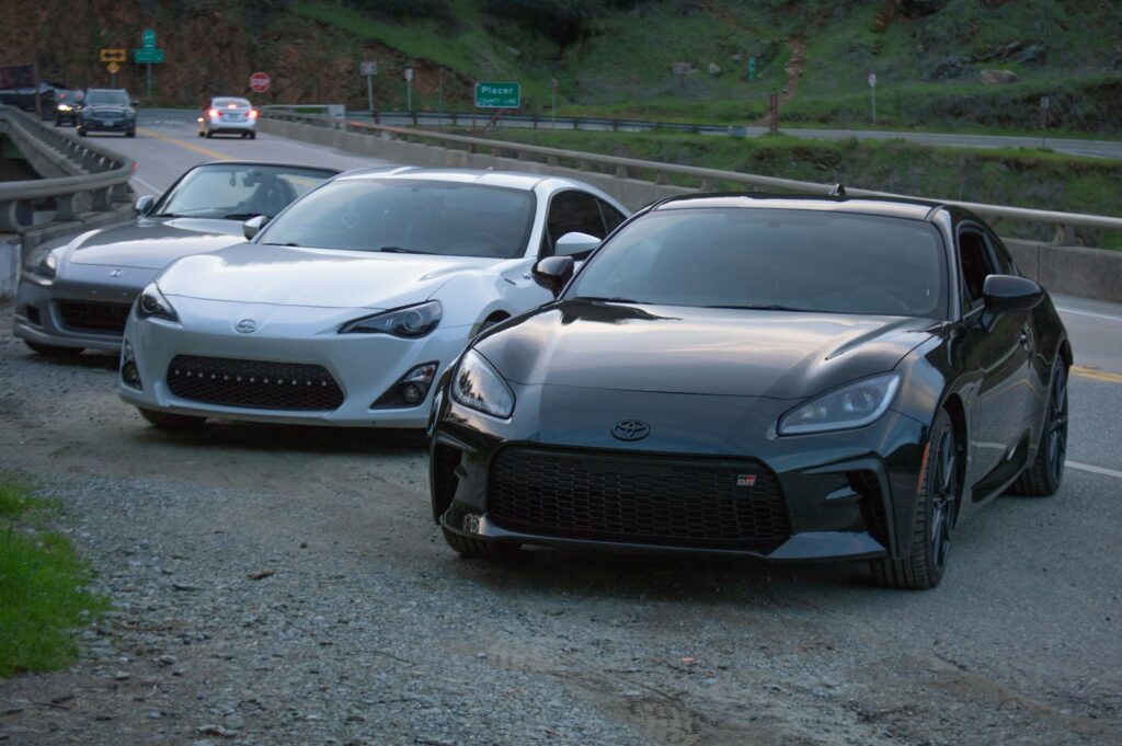 a couple of cars parked on the side of a road