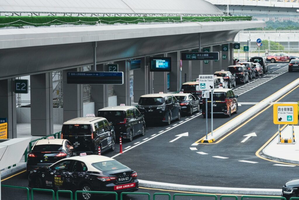 Taxis lined up at a modern transportation hub.
