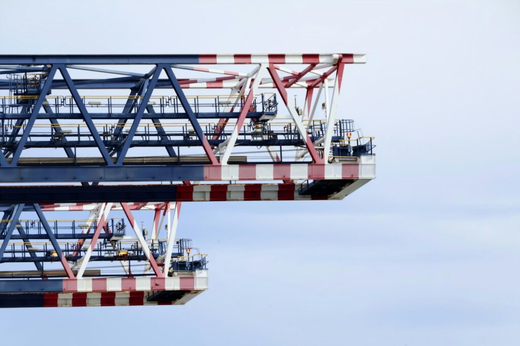 Two industrial bridge sections against a pale sky