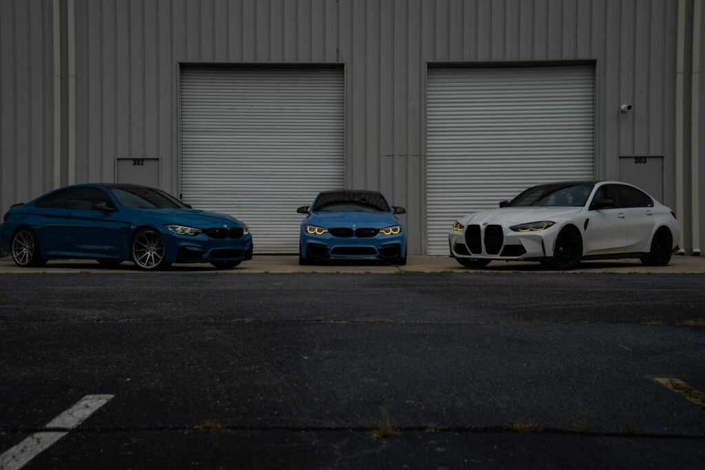 Three bmws parked in front of a building.