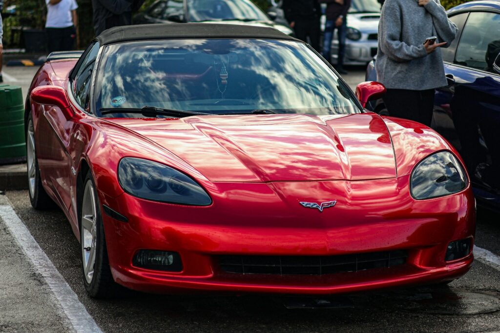 A red sports car parked in a parking lot