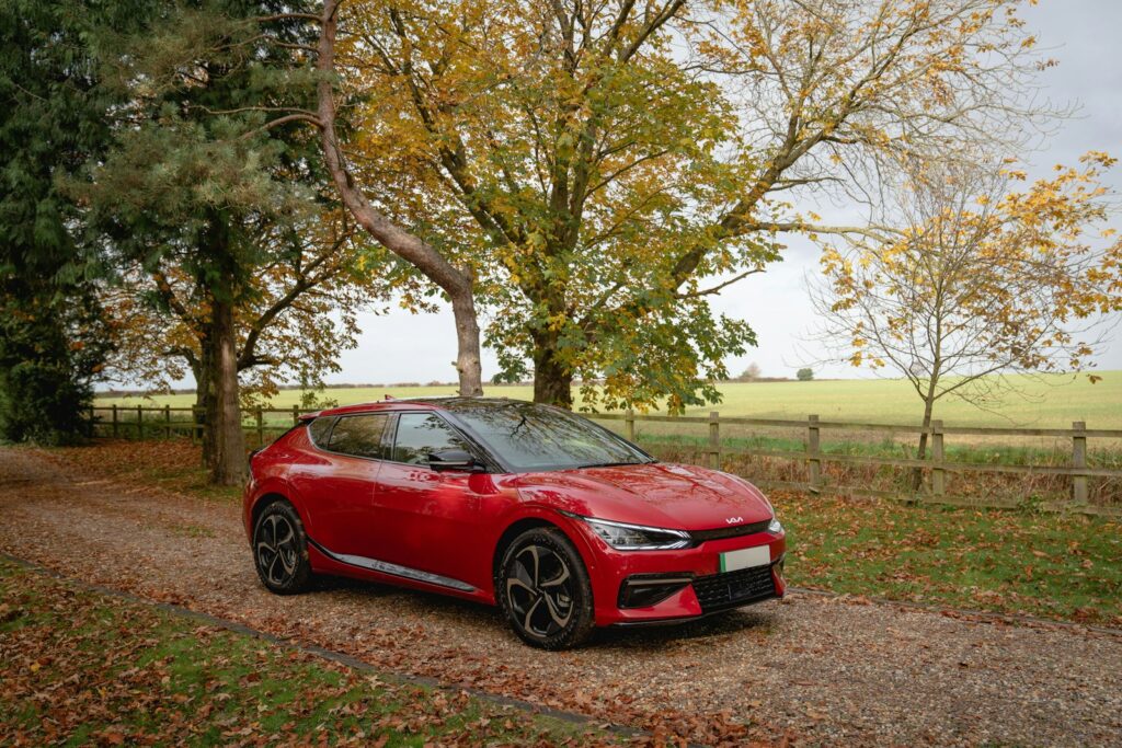 Red electric car parked on a gravel road