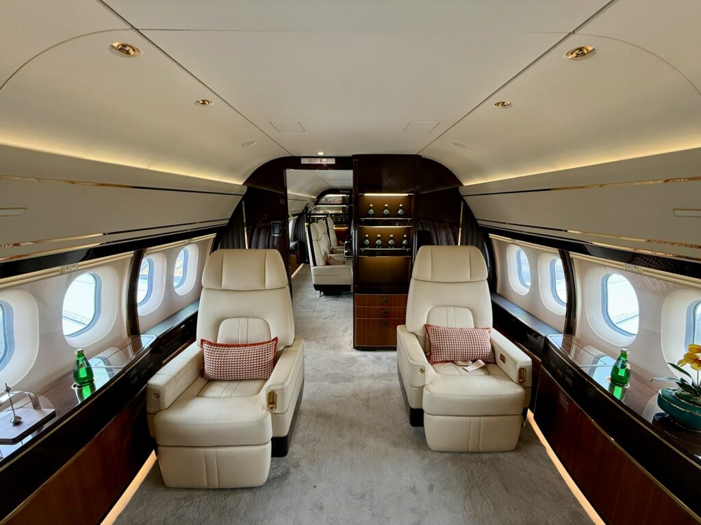 Luxurious interior of a private jet with comfortable seating.