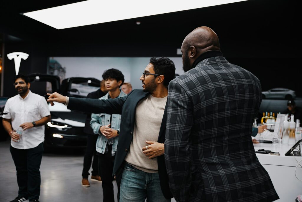 A group of people standing around a car showroom