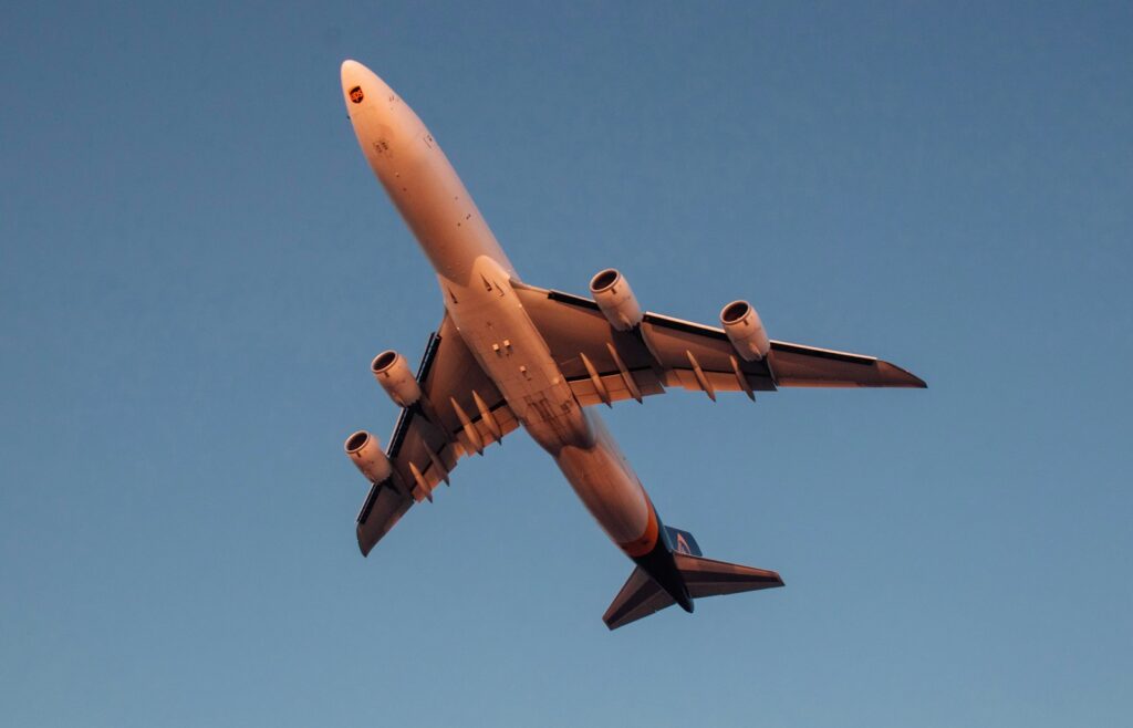 a large jetliner flying through a blue sky