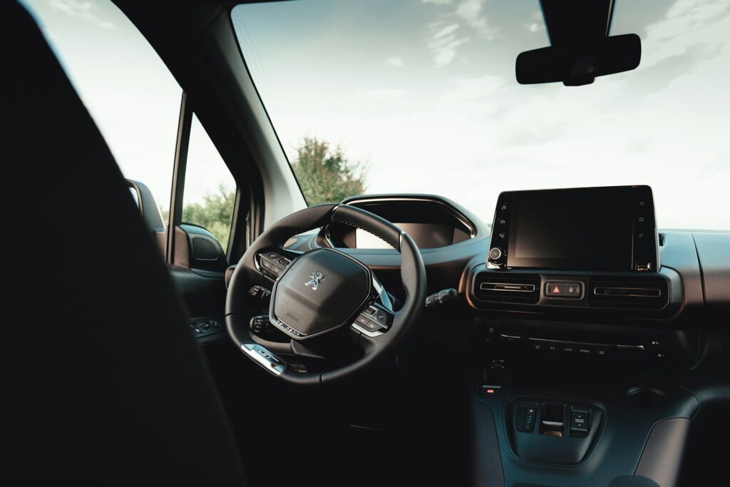 the interior of a car with a steering wheel and dashboard