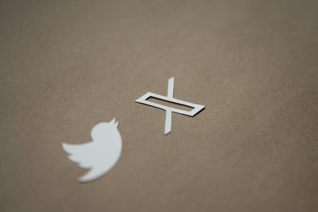 a white twitter logo and a white twitter sticker
