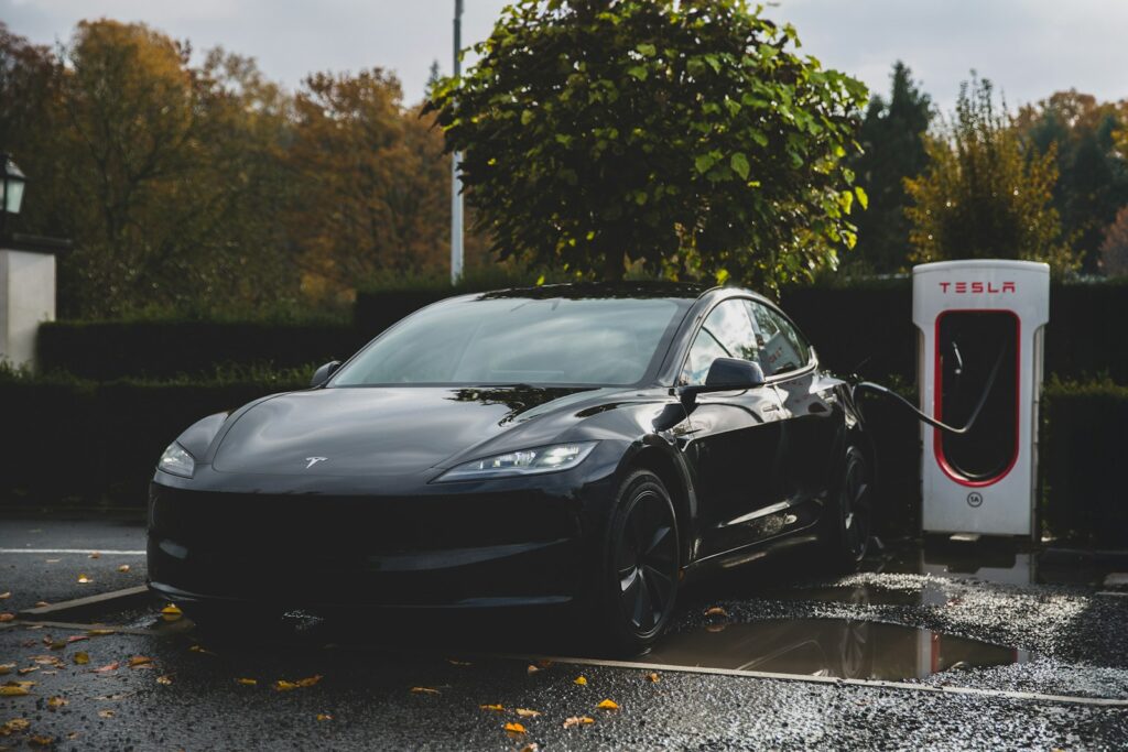 a tesla electric car charging at a charging station