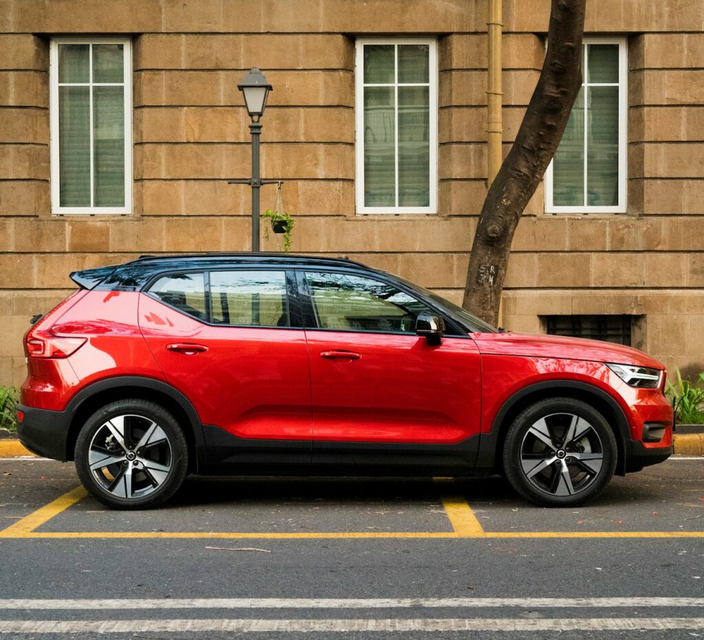 a red car parked in front of a building