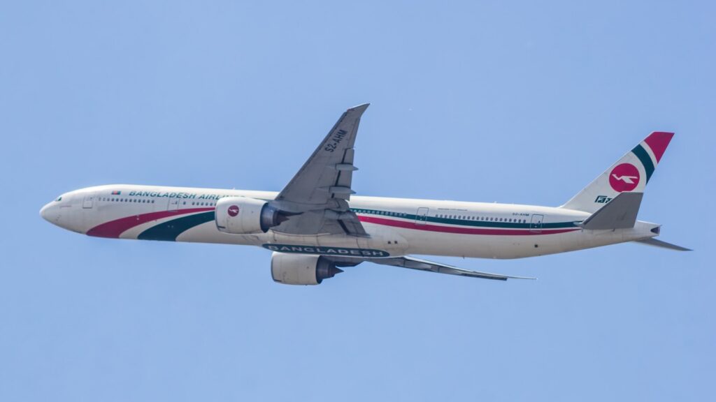 A large jetliner flying through a blue sky