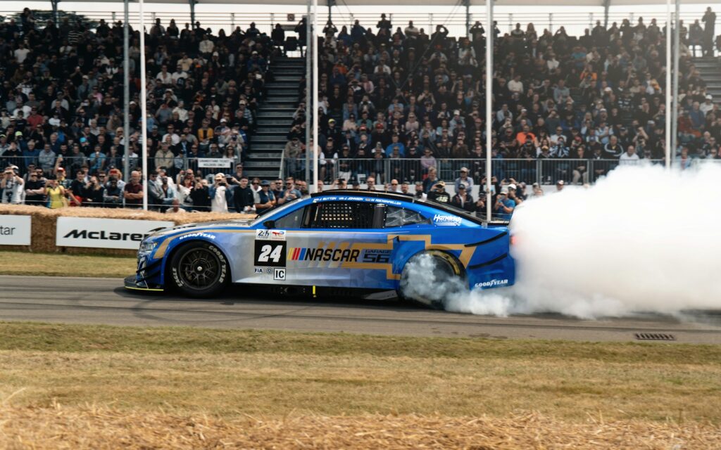 Race car performing a burnout with smoke billowing.