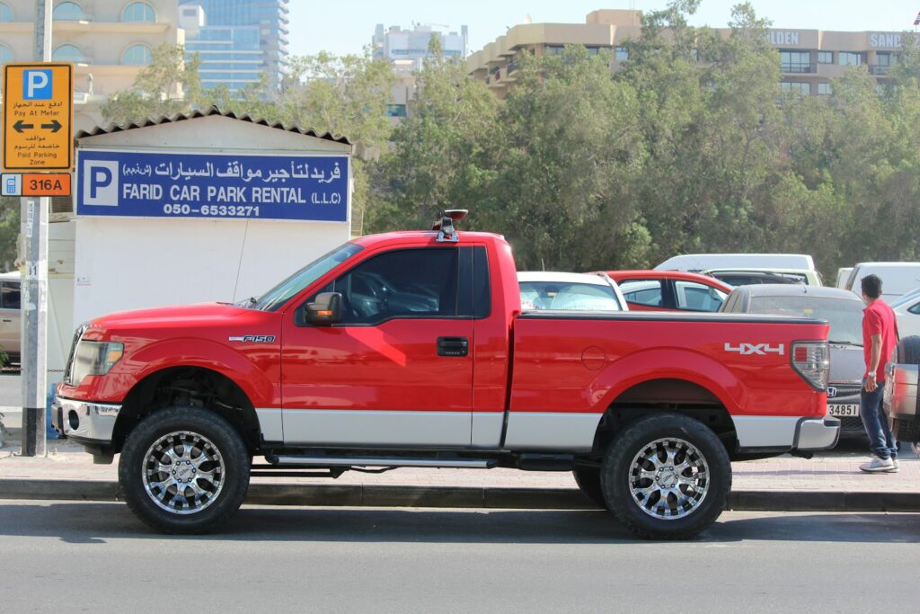 a red truck parked on the side of a road