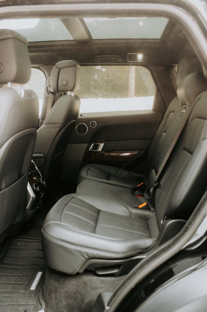 Explore the sleek design and comfort of a modern car interior featuring black leather seats and panoramic sunroof.